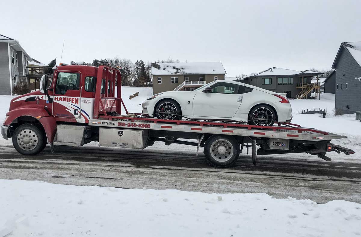 Hanifen Towing truck working a winter call during an Iowa tow ban season